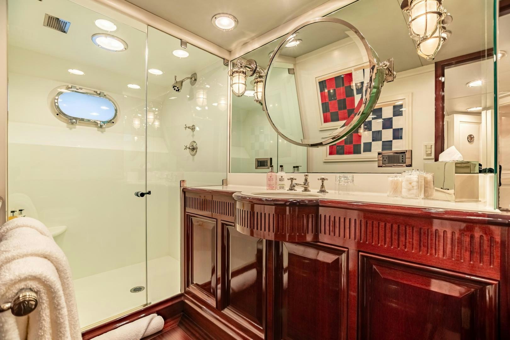 a bathroom with a large mirror aboard EXPLORA Yacht for Sale