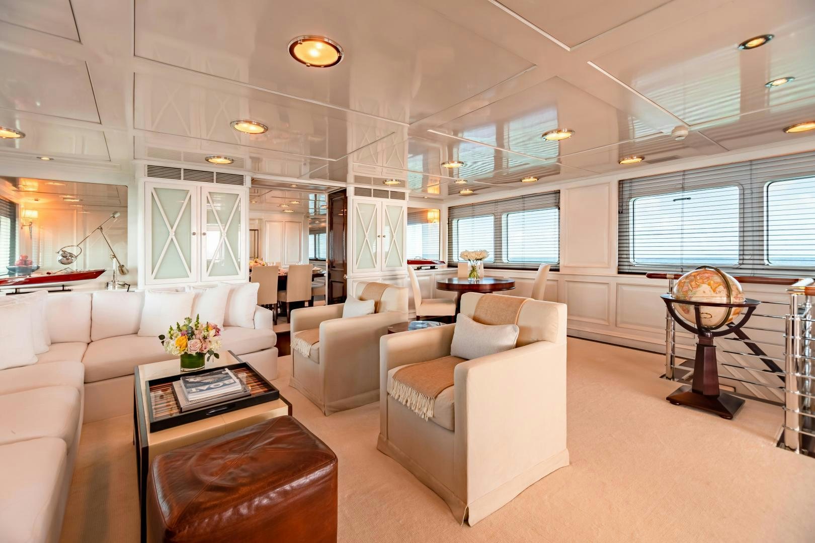 a living room with a large window aboard EXPLORA Yacht for Sale
