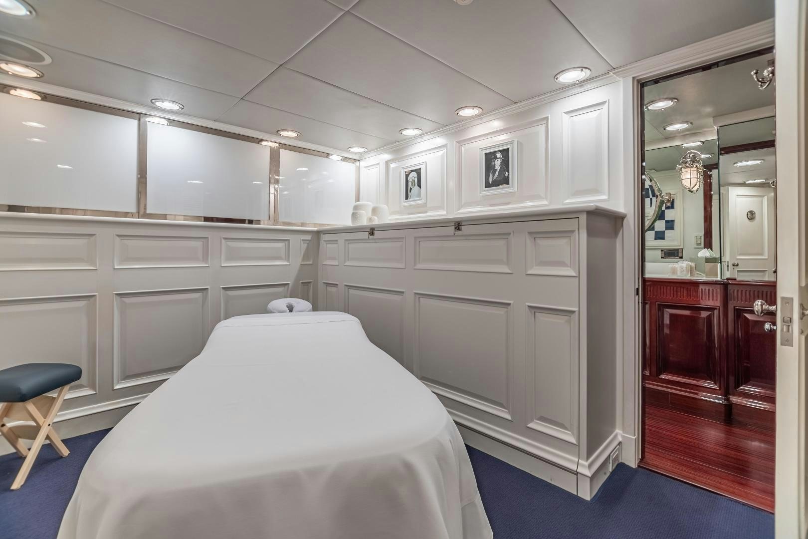 a room with a bed and a mirror aboard EXPLORA Yacht for Sale