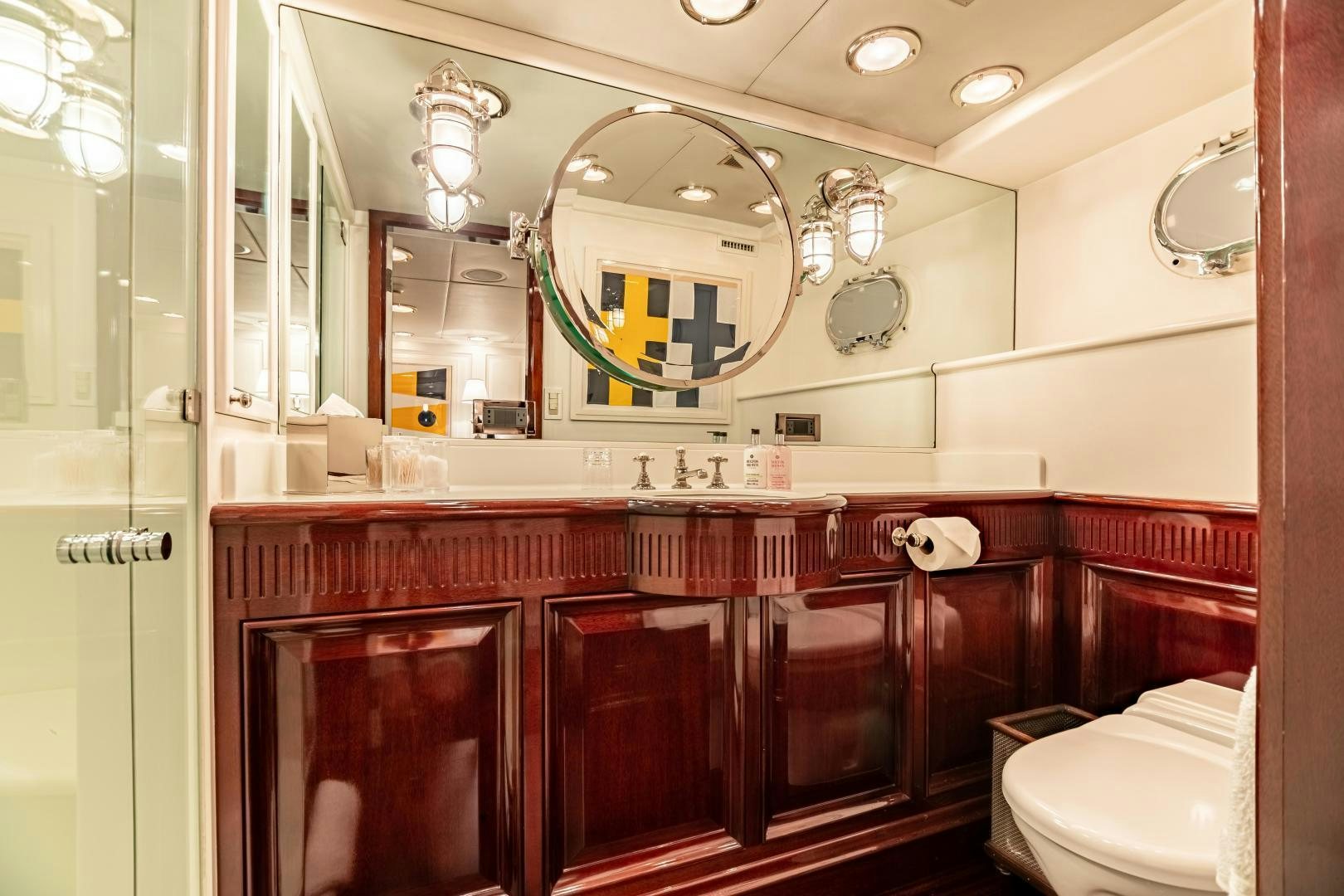a bathroom with a large mirror aboard EXPLORA Yacht for Sale