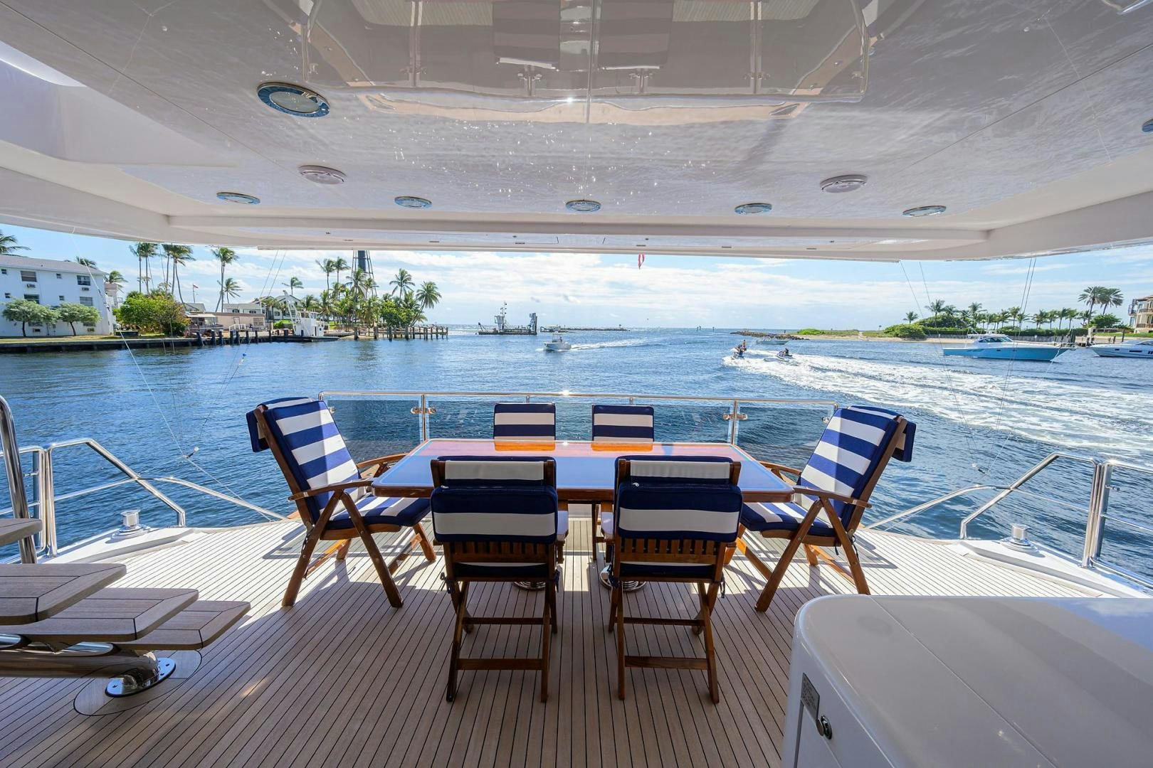 a table and chairs on a deck aboard THE CROWN ROYAL Yacht for Sale
