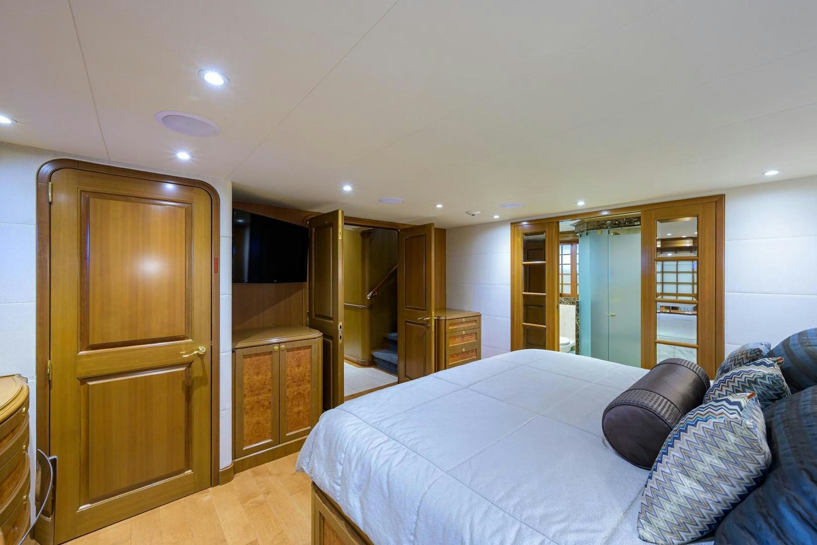 a bedroom with a bed and a closet aboard THE CROWN ROYAL Yacht for Sale
