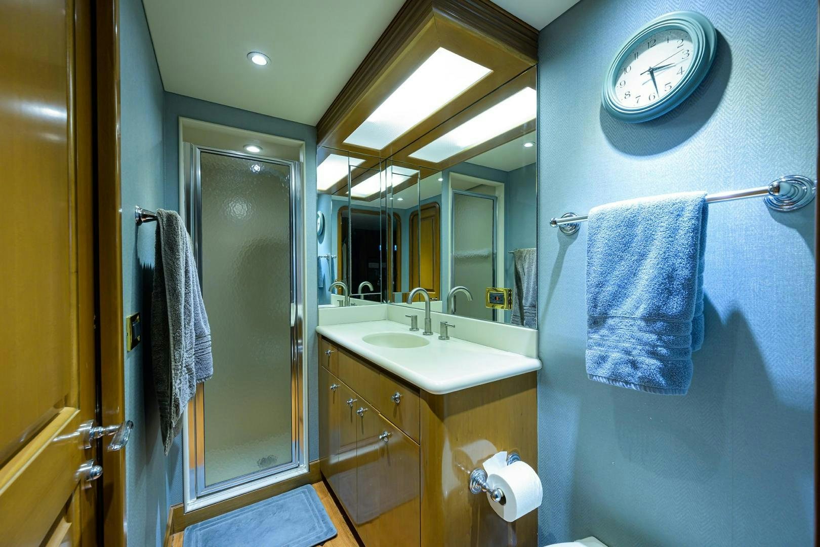 a bathroom with a sink and a mirror aboard THE CROWN ROYAL Yacht for Sale