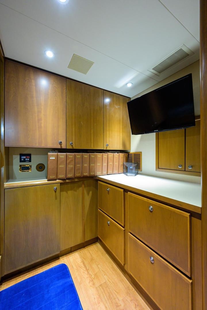 a kitchen with wooden cabinets aboard THE CROWN ROYAL Yacht for Sale