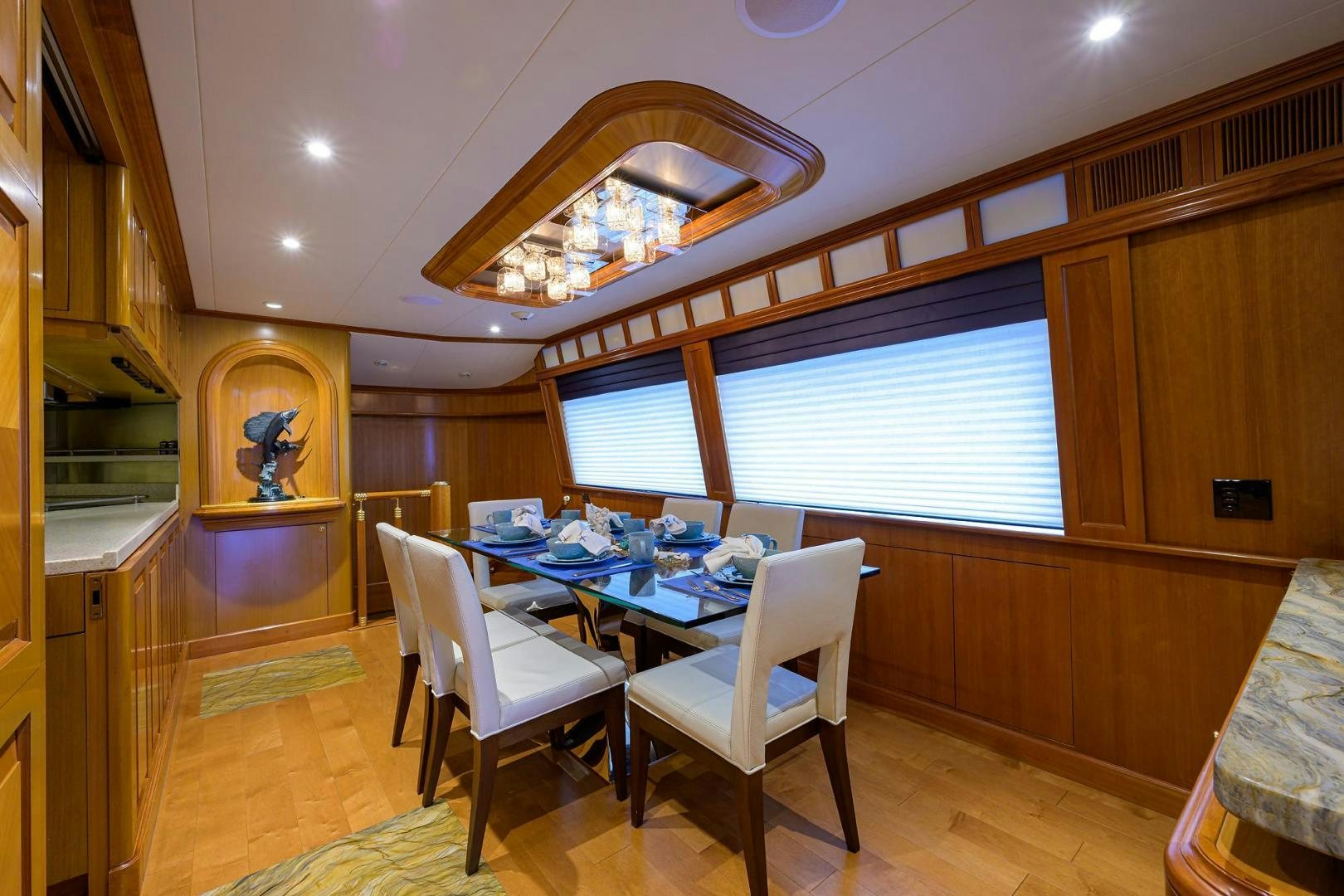 a dining room with a table and chairs aboard THE CROWN ROYAL Yacht for Sale