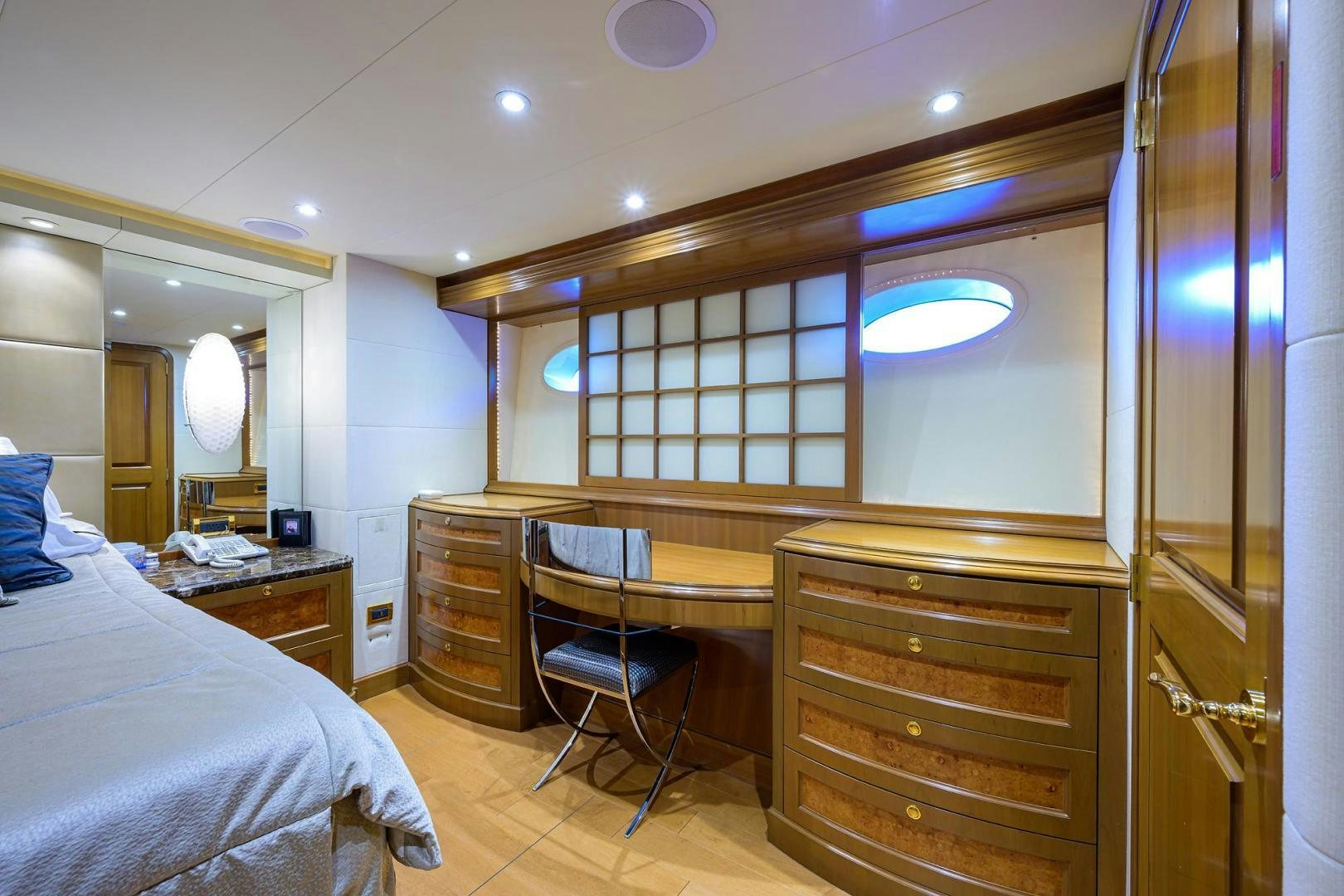 a bedroom with a bed and a desk aboard THE CROWN ROYAL Yacht for Sale