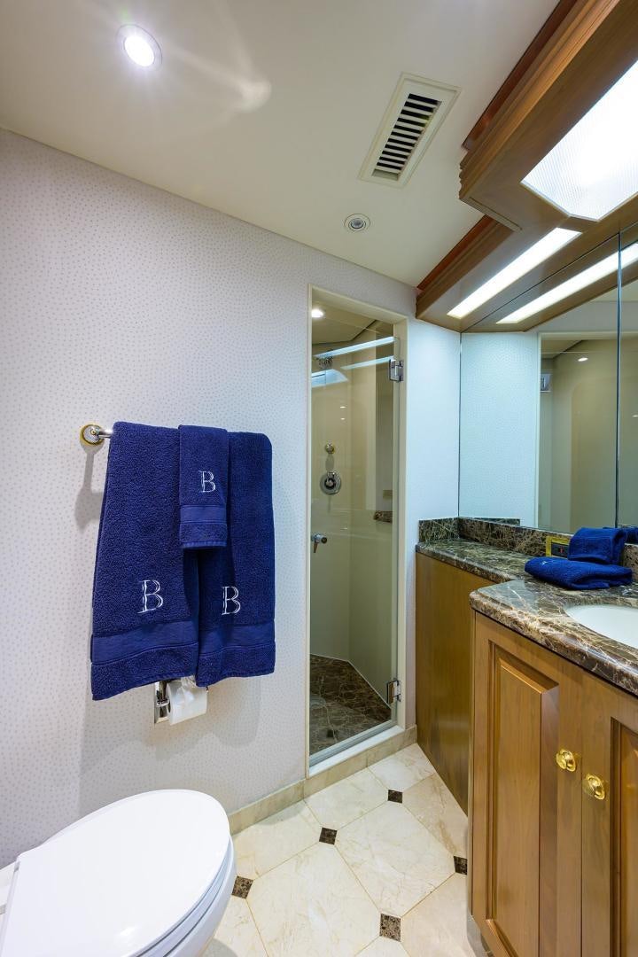 a bathroom with a blue towel on the wall aboard THE CROWN ROYAL Yacht for Sale