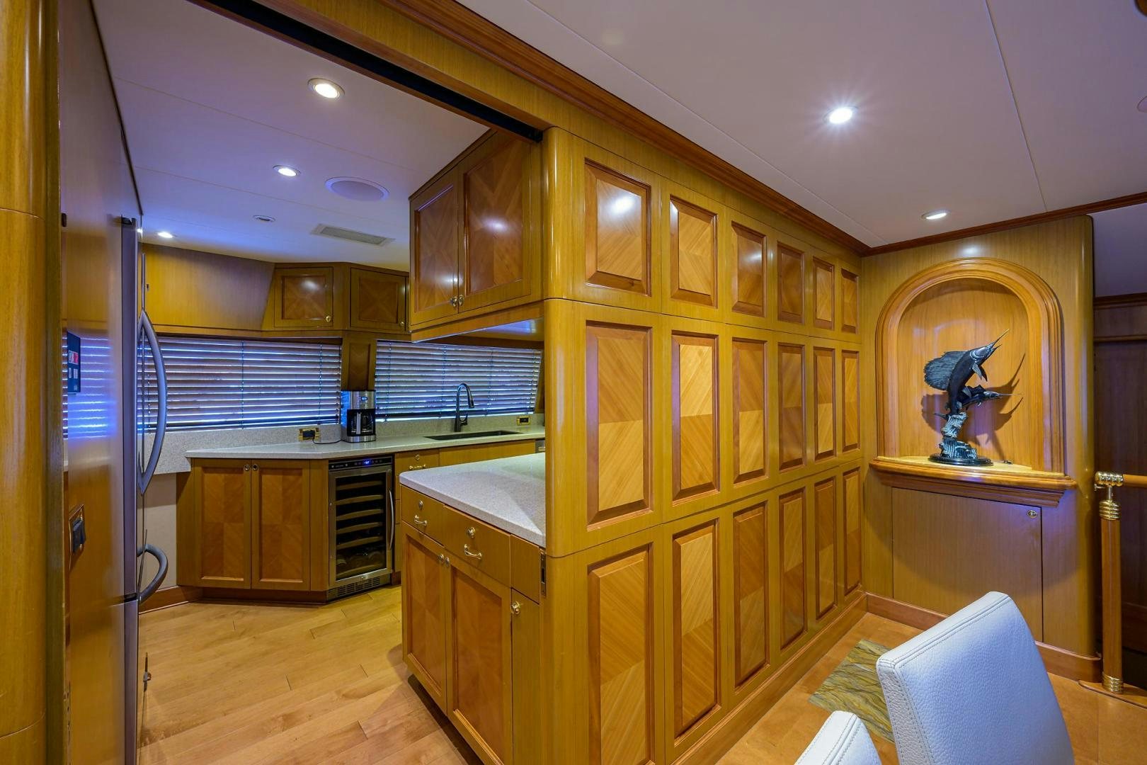 a kitchen with wooden cabinets aboard THE CROWN ROYAL Yacht for Sale