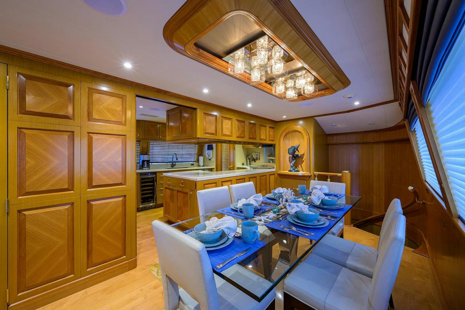 a dining room with a table and chairs aboard THE CROWN ROYAL Yacht for Sale