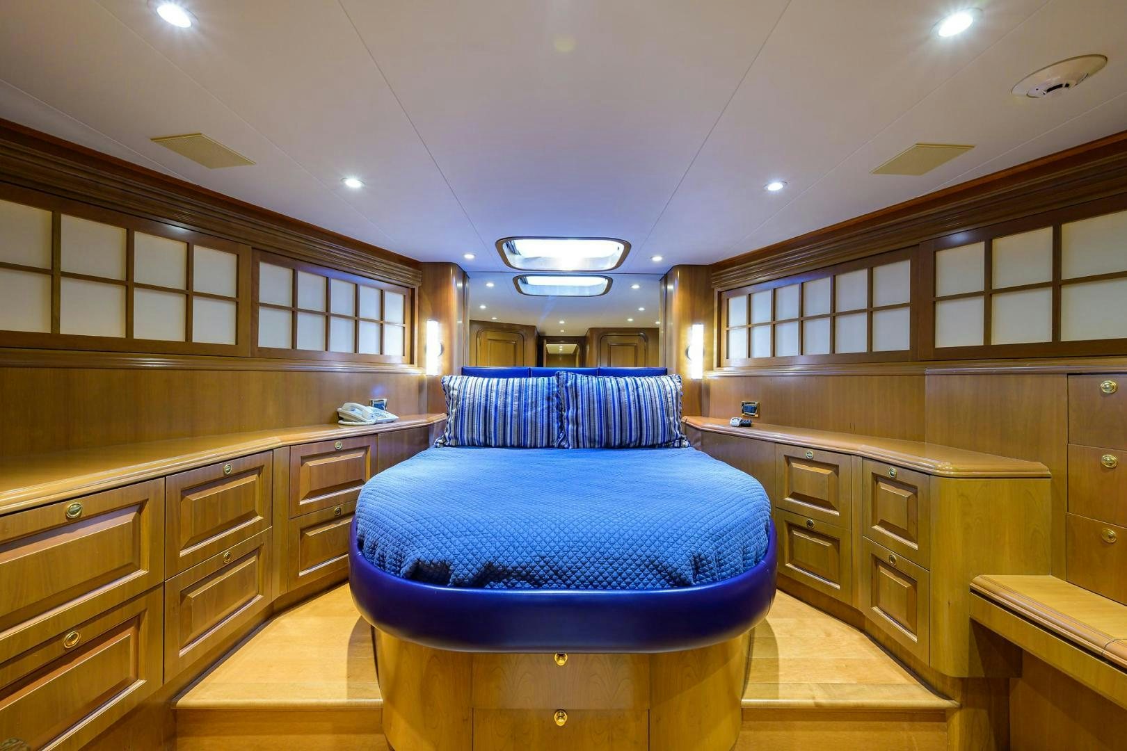 a large room with a bed and cabinets aboard THE CROWN ROYAL Yacht for Sale