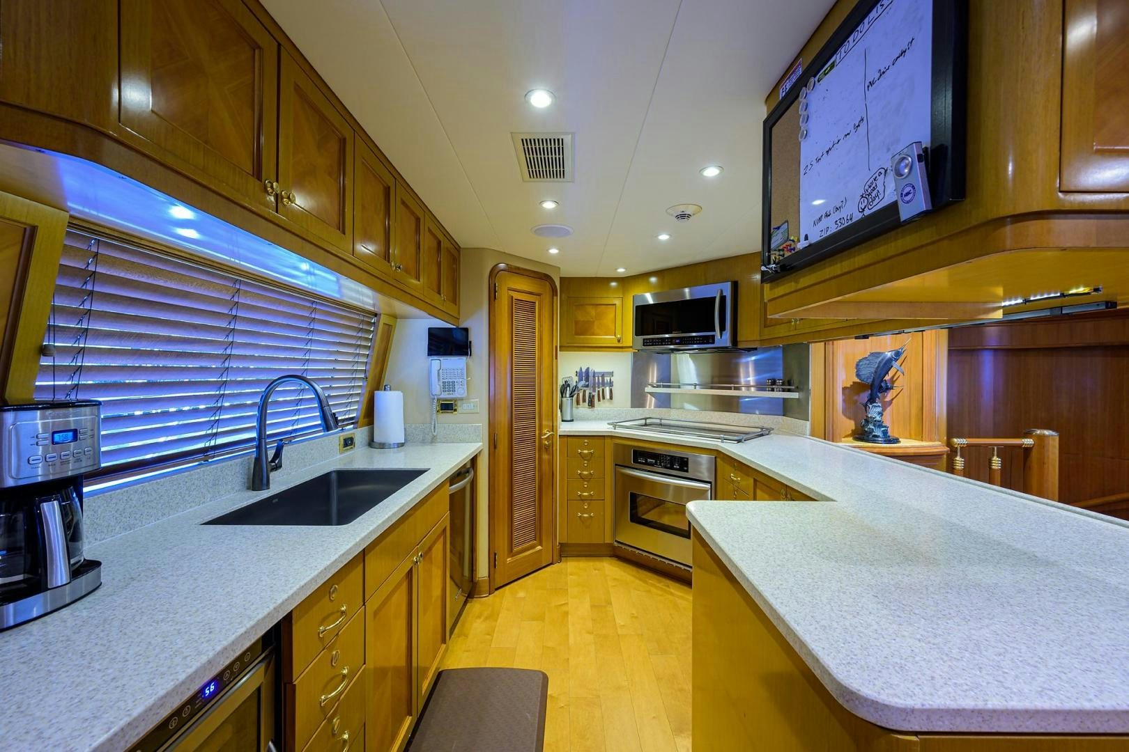 a kitchen with a large island aboard THE CROWN ROYAL Yacht for Sale