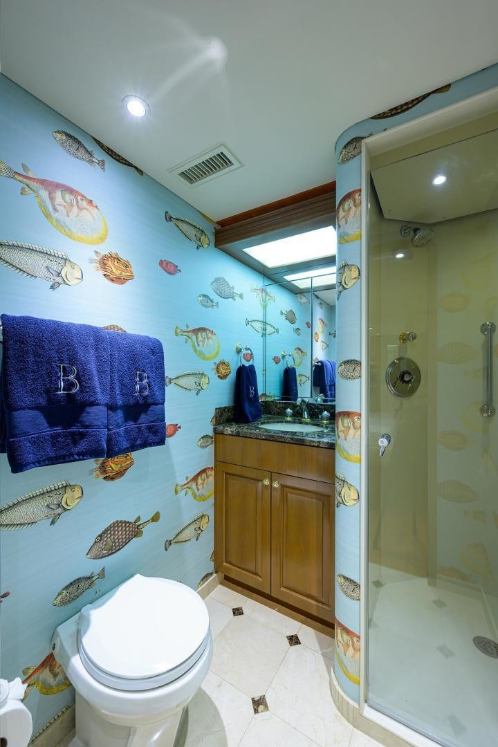 a bathroom with a toilet and a sink aboard THE CROWN ROYAL Yacht for Sale