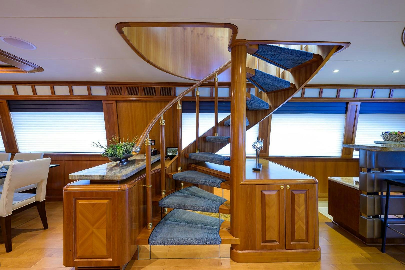 a room with a wood staircase and a large window aboard THE CROWN ROYAL Yacht for Sale