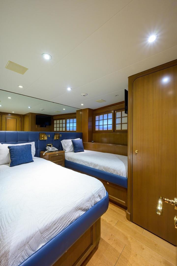 a room with two beds aboard THE CROWN ROYAL Yacht for Sale