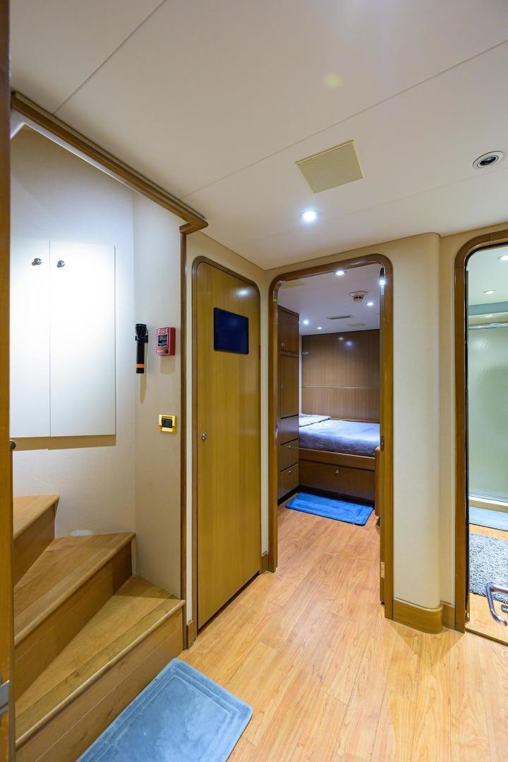 a room with a bed and a mirror aboard THE CROWN ROYAL Yacht for Sale
