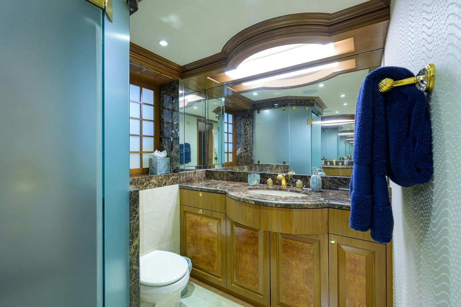 a bathroom with a blue towel over the sink aboard THE CROWN ROYAL Yacht for Sale