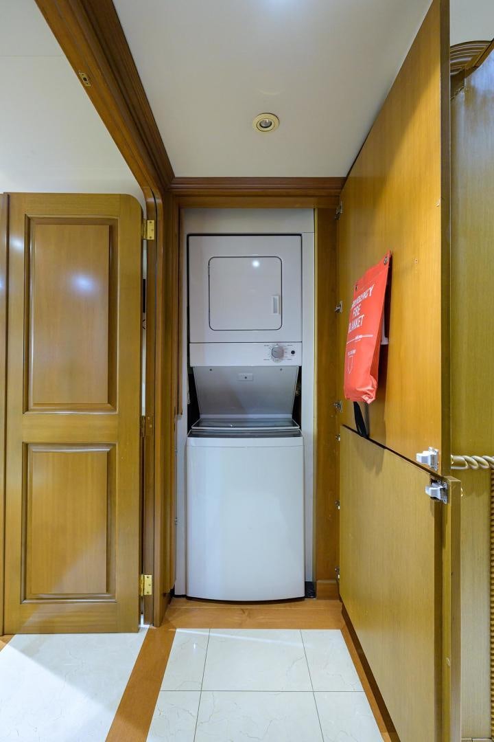 a kitchen with a refrigerator and microwave aboard THE CROWN ROYAL Yacht for Sale