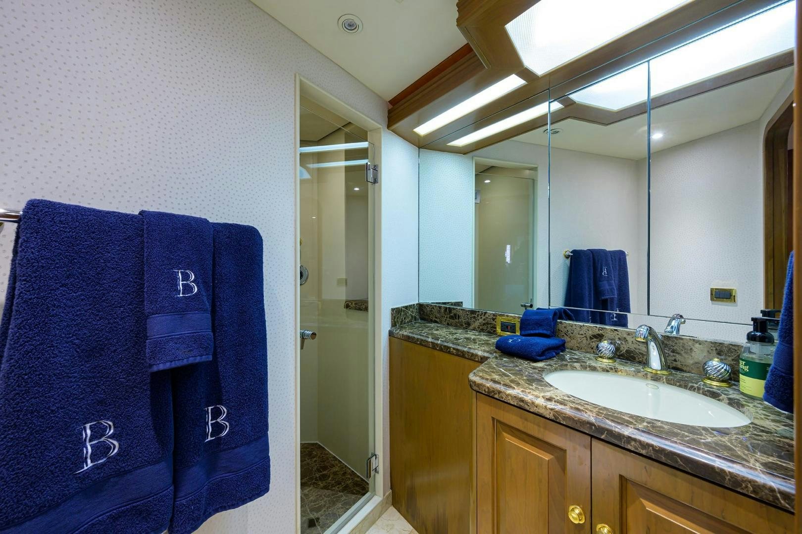 a bathroom with a sink and a mirror aboard THE CROWN ROYAL Yacht for Sale