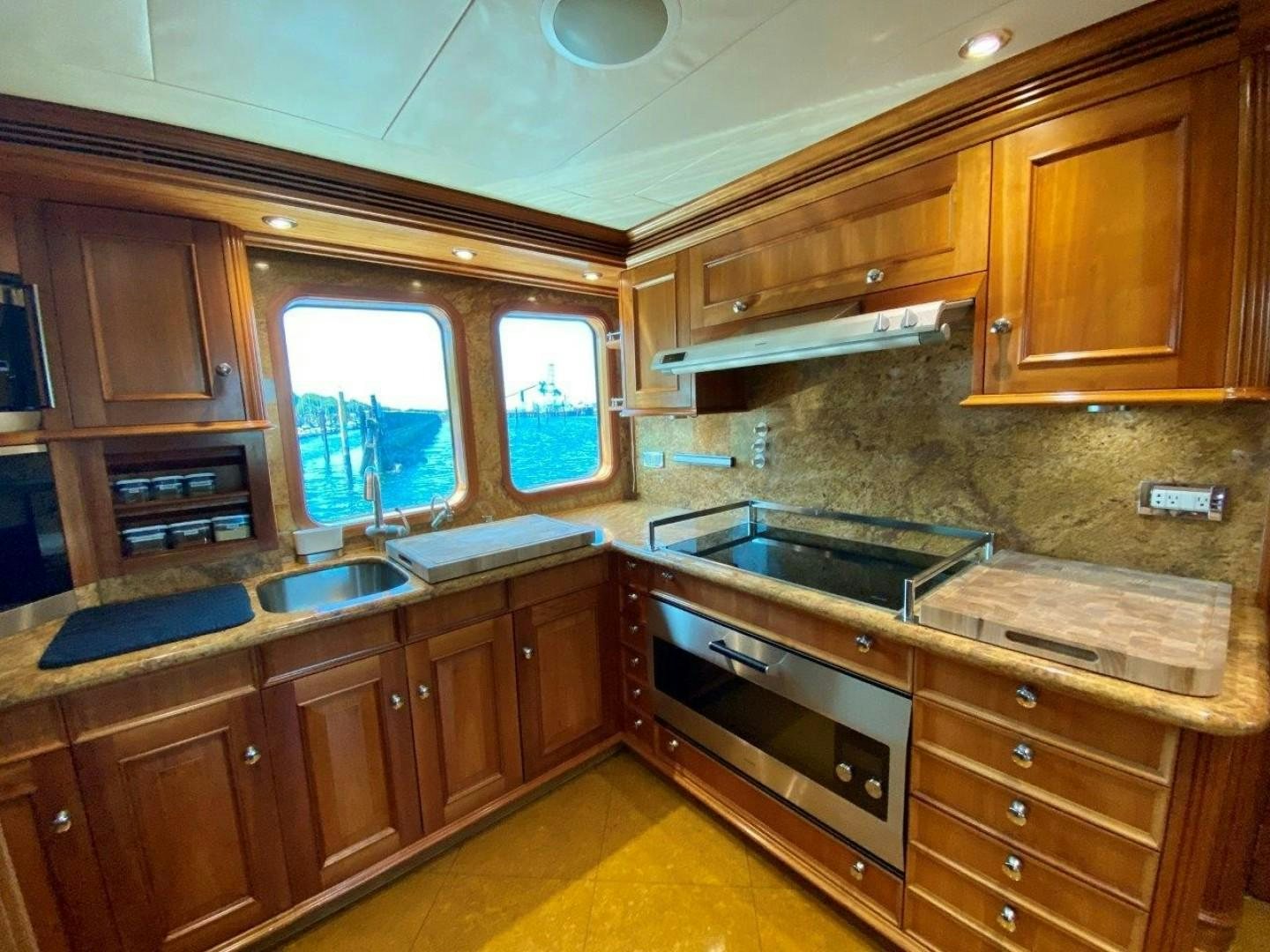 a kitchen with wooden cabinets aboard COASTAL DRIFTER Yacht for Sale