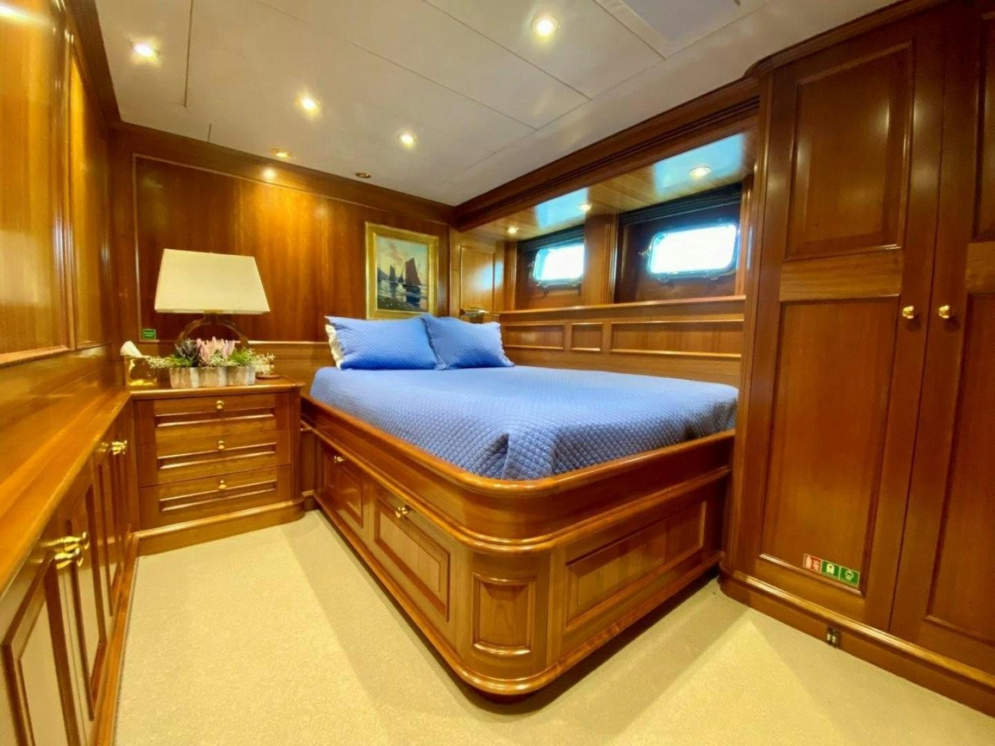 a bedroom with a bed and a desk aboard COASTAL DRIFTER Yacht for Sale