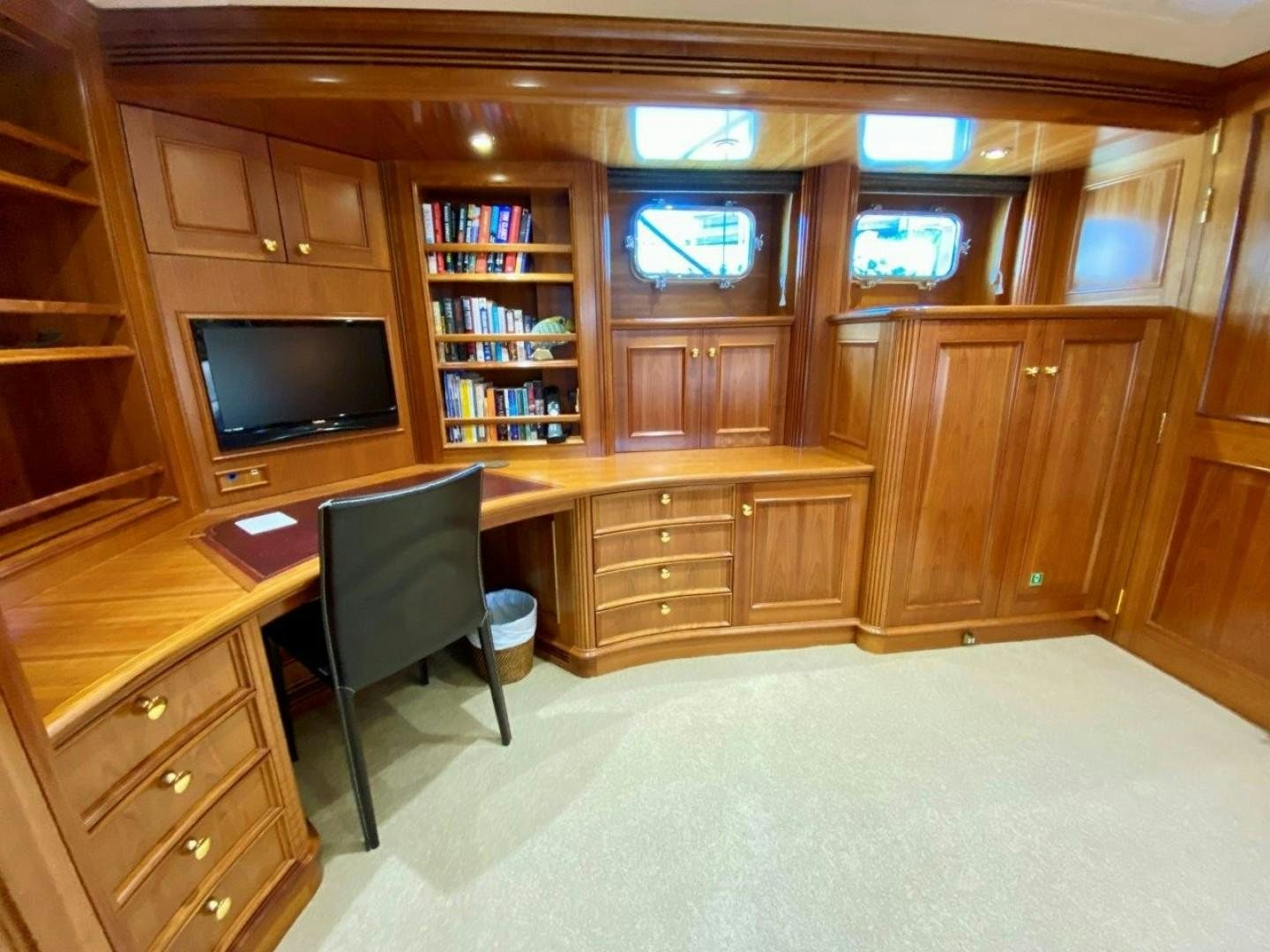 a room with a tv and a chair aboard COASTAL DRIFTER Yacht for Sale