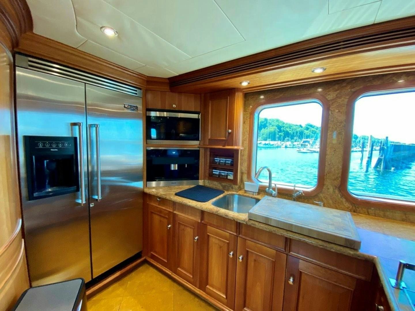 a kitchen with wooden cabinets aboard COASTAL DRIFTER Yacht for Sale