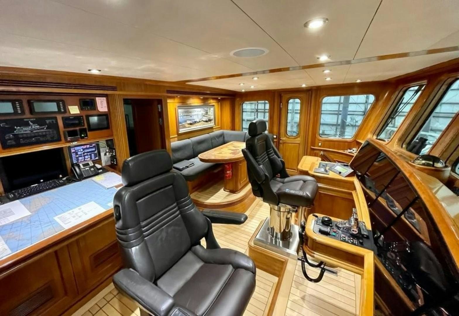a room with a piano and a desk with chairs aboard COASTAL DRIFTER Yacht for Sale