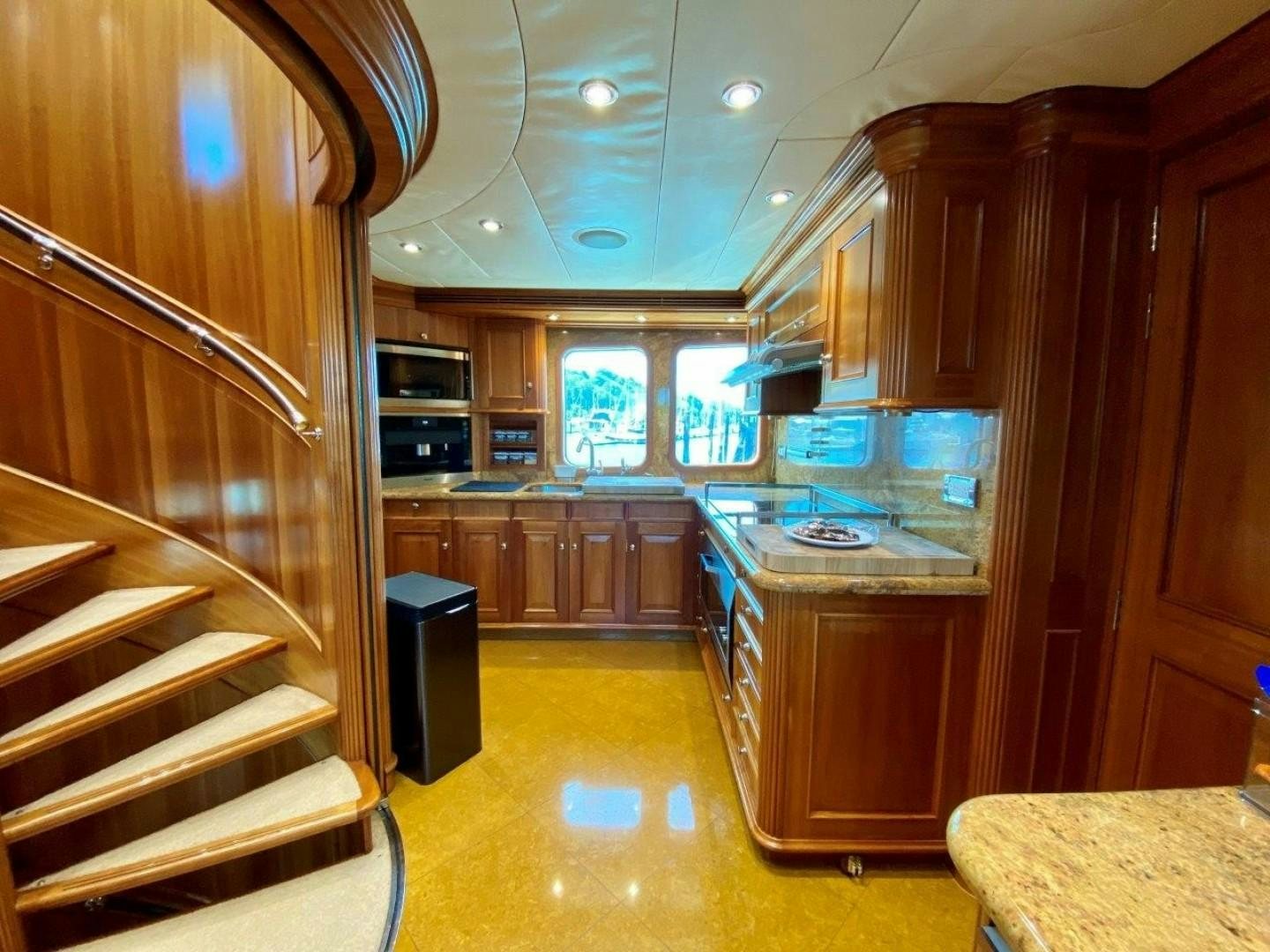 a kitchen with wooden cabinets aboard COASTAL DRIFTER Yacht for Sale