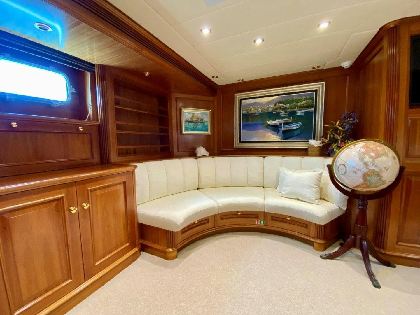 a living room with a couch and a globe aboard COASTAL DRIFTER Yacht for Sale