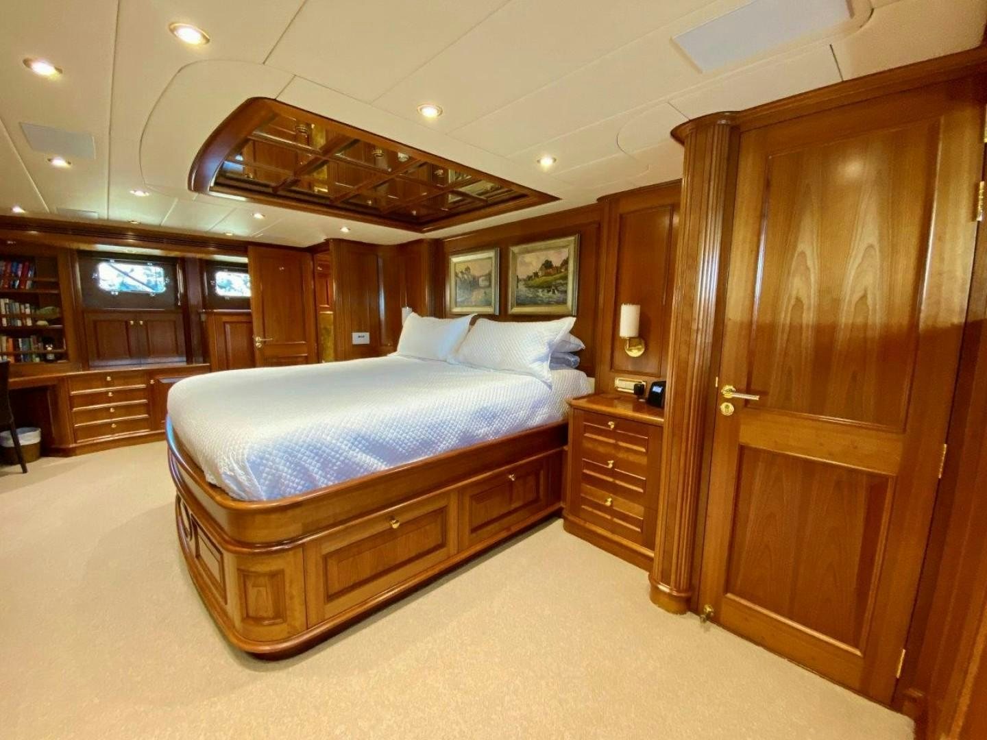 a bedroom with a bed and a closet aboard COASTAL DRIFTER Yacht for Sale
