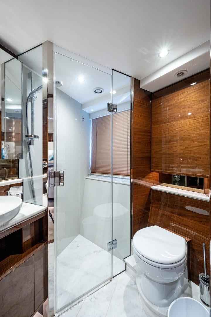 a bathroom with a glass shower aboard I Love It Yacht for Sale