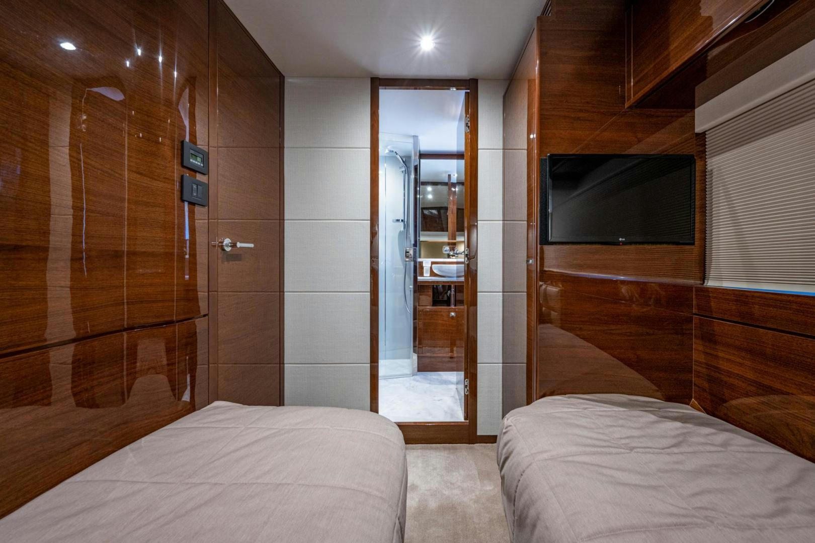a bedroom with a bed and a television aboard I Love It Yacht for Sale