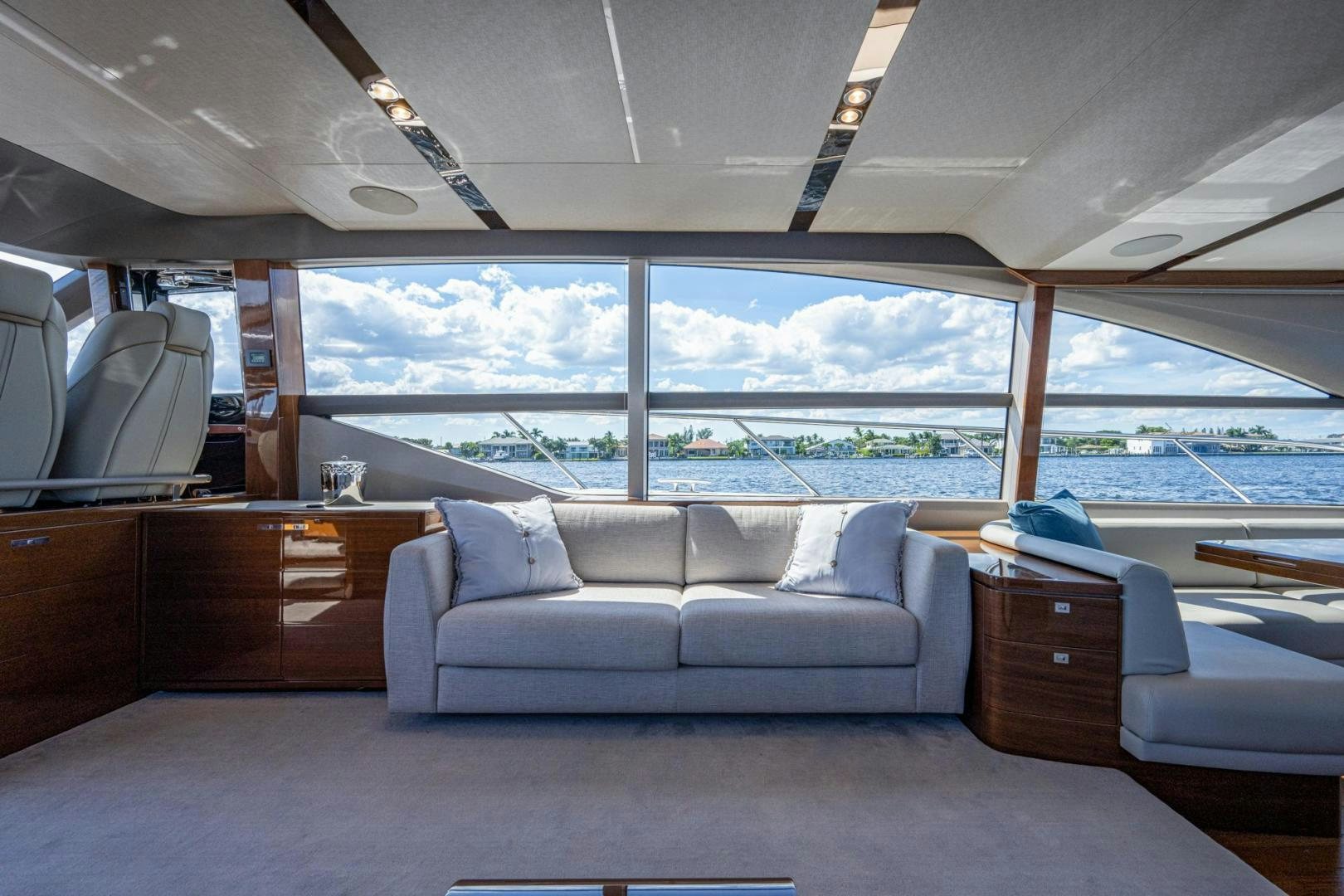 a room with a couch and a view of the ocean aboard I Love It Yacht for Sale