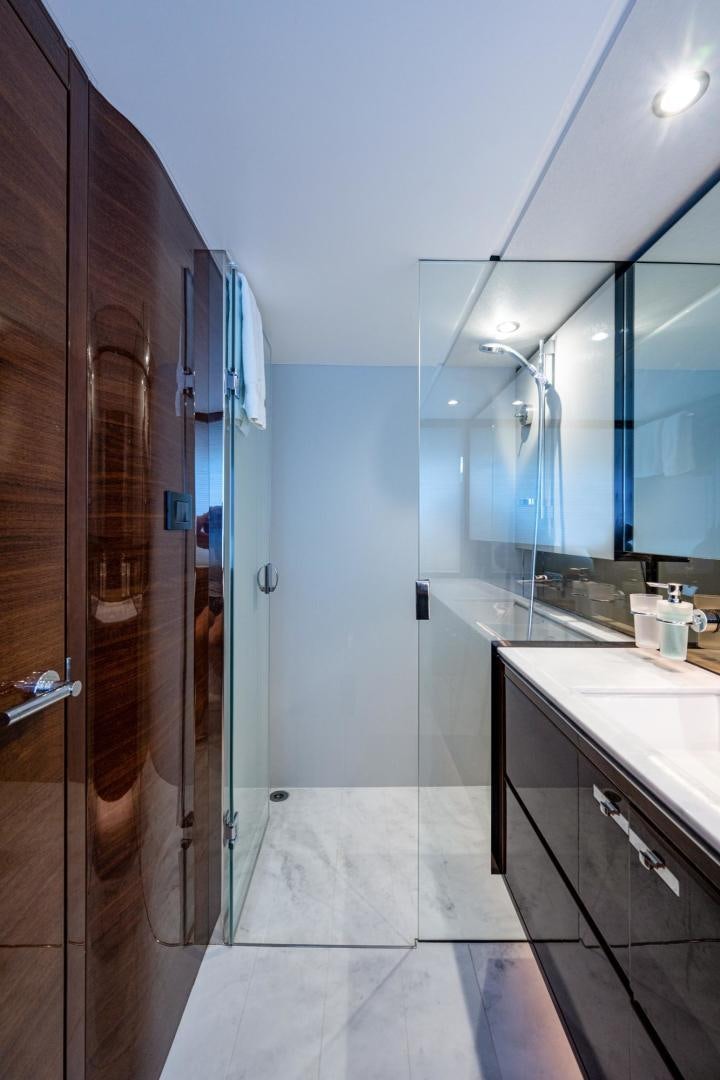 a bathroom with a glass shower aboard I Love It Yacht for Sale
