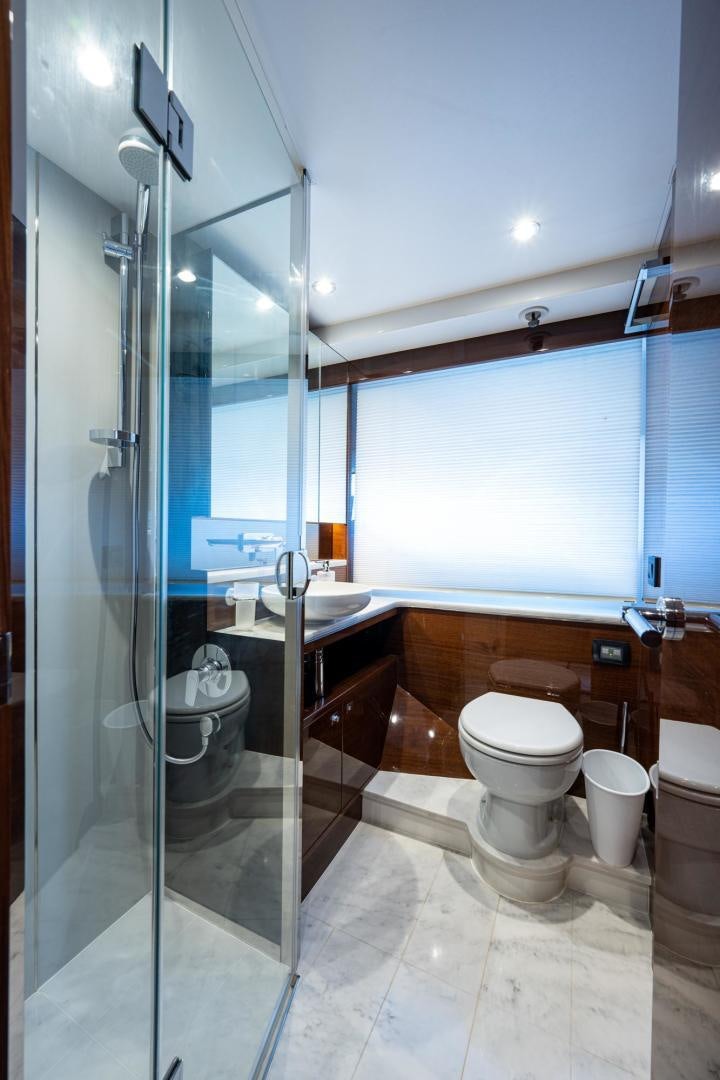 a bathroom with a glass shower aboard I Love It Yacht for Sale