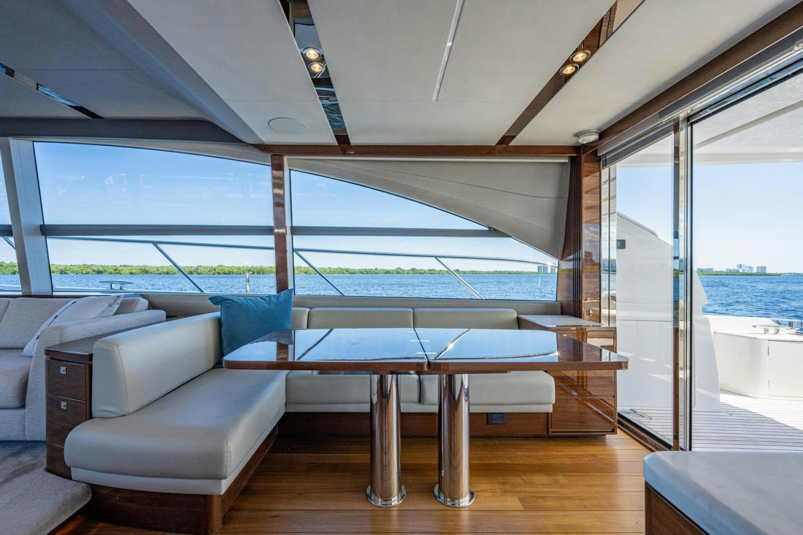 a room with a couch and a table and a large window aboard I Love It Yacht for Sale