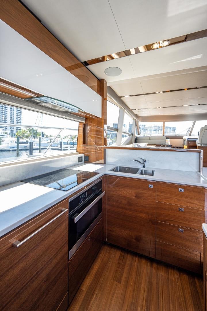 a kitchen with wooden cabinets aboard I Love It Yacht for Sale