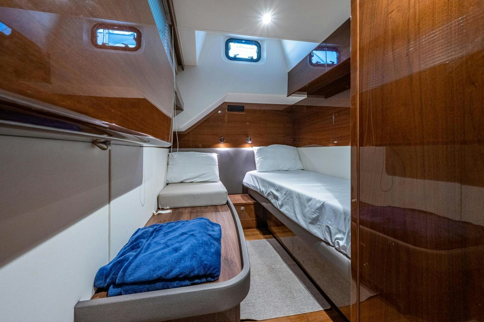 a room with beds and a wood wall aboard I Love It Yacht for Sale