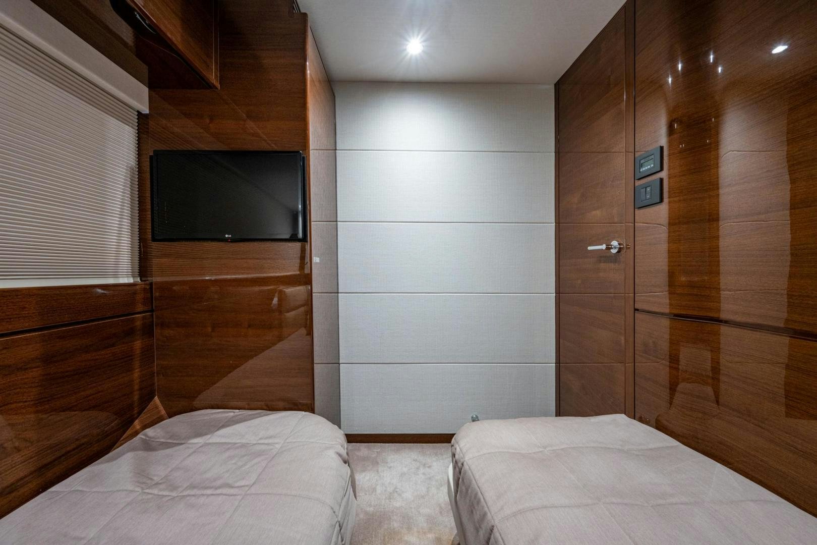 a room with a bed and a television aboard I Love It Yacht for Sale
