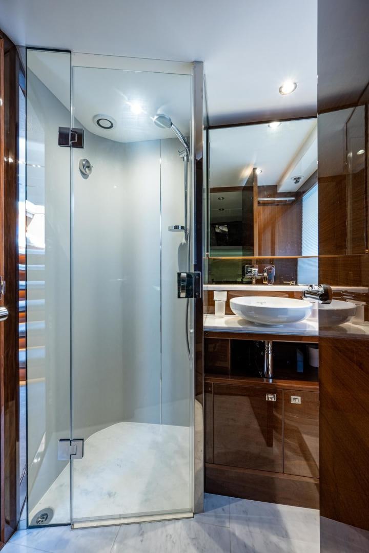 a bathroom with a shower unit and sink aboard I Love It Yacht for Sale