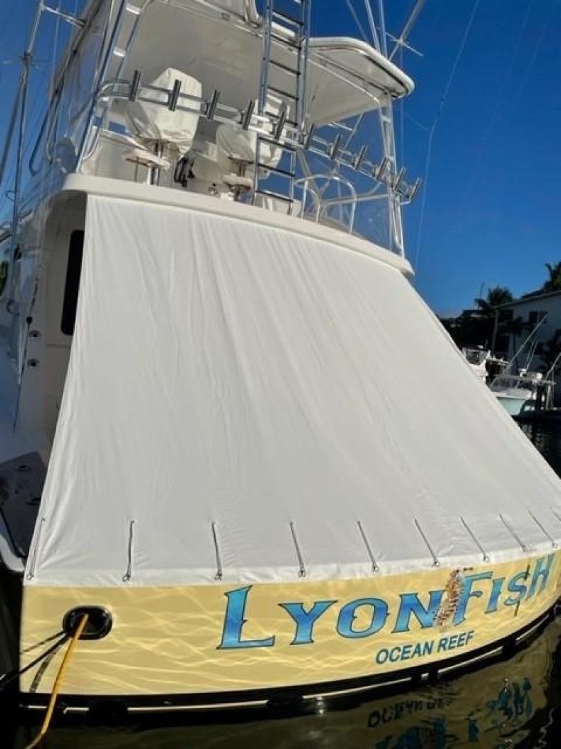 a white boat with blue lettering aboard LYON FISH Yacht for Sale