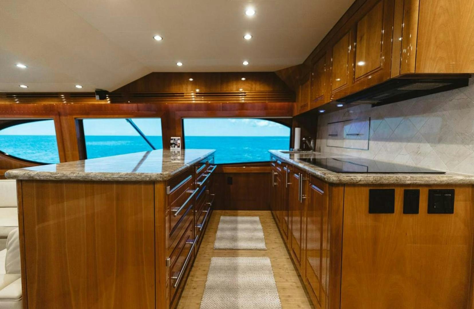 a kitchen with wooden cabinets aboard LYON FISH Yacht for Sale