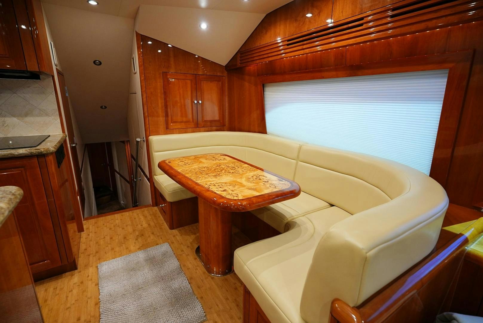 a living room with a table and chairs aboard LYON FISH Yacht for Sale