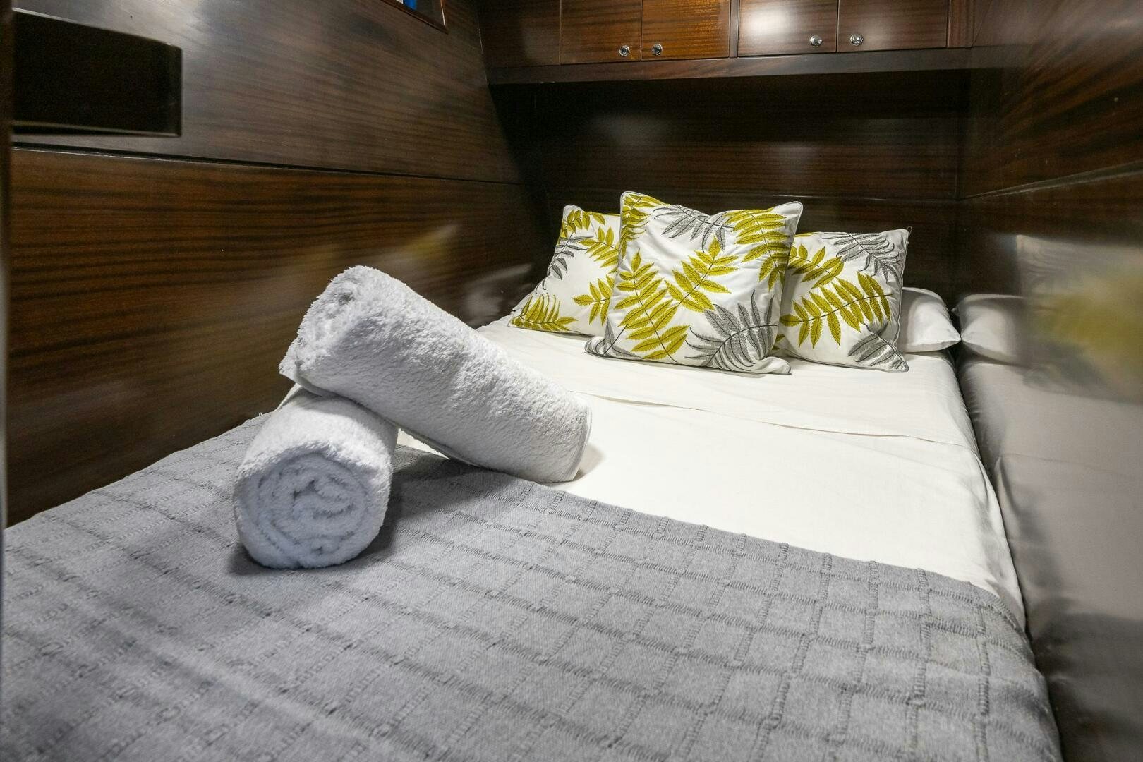 a pair of white socks on a bed aboard KAHUNA Yacht for Sale