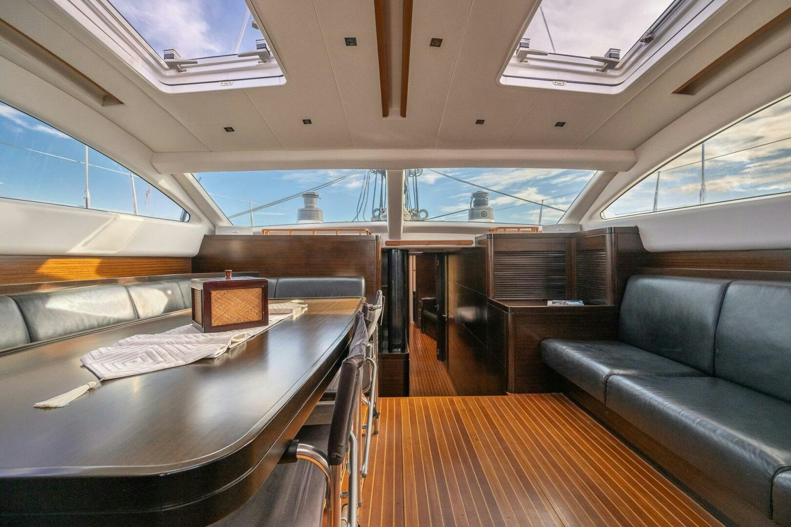 a room with a table and couch aboard KAHUNA Yacht for Sale