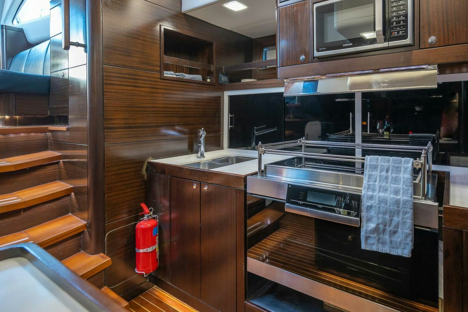 a kitchen with wooden cabinets aboard KAHUNA Yacht for Sale