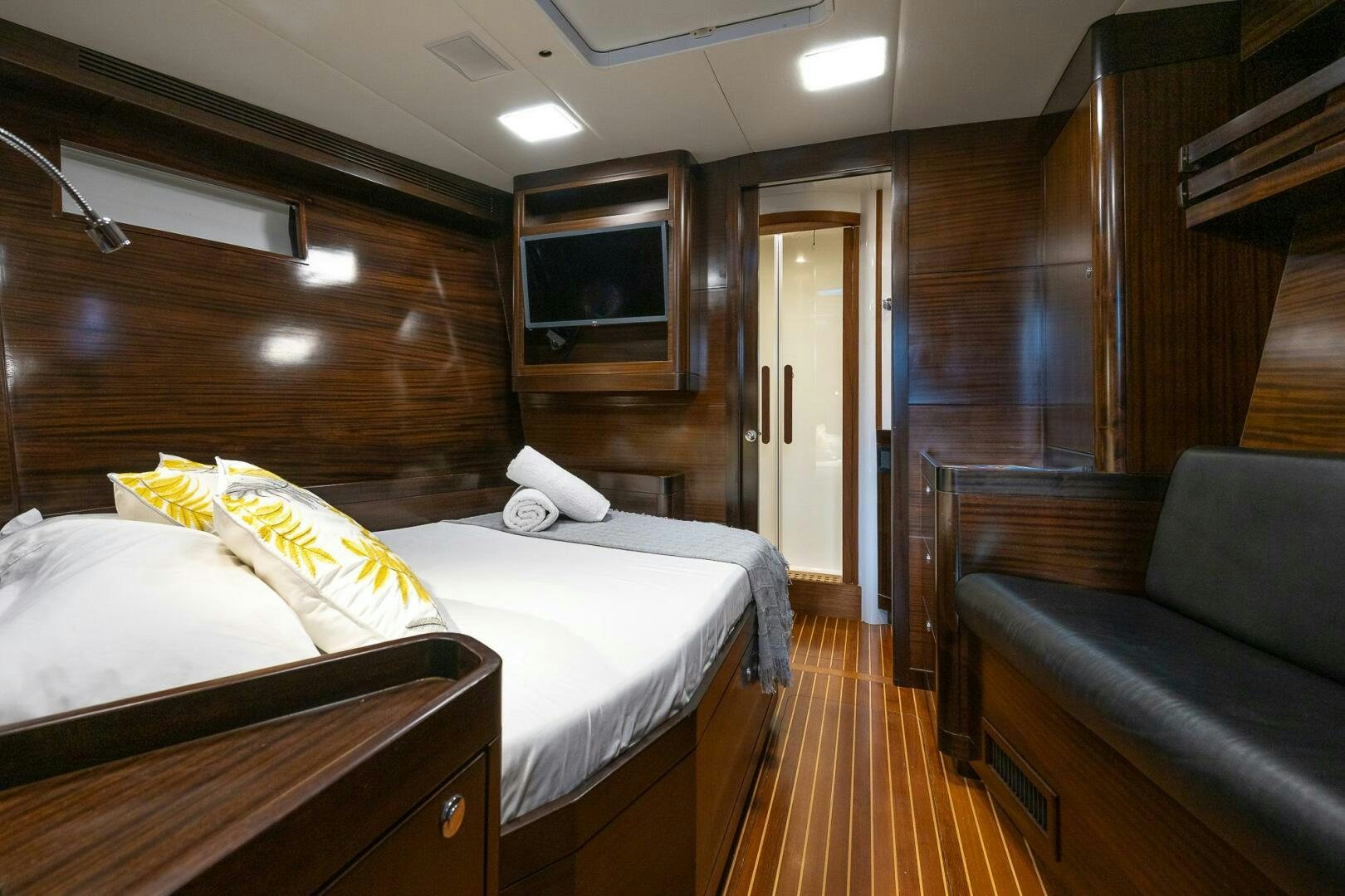 a bedroom with a bed and a couch aboard KAHUNA Yacht for Sale