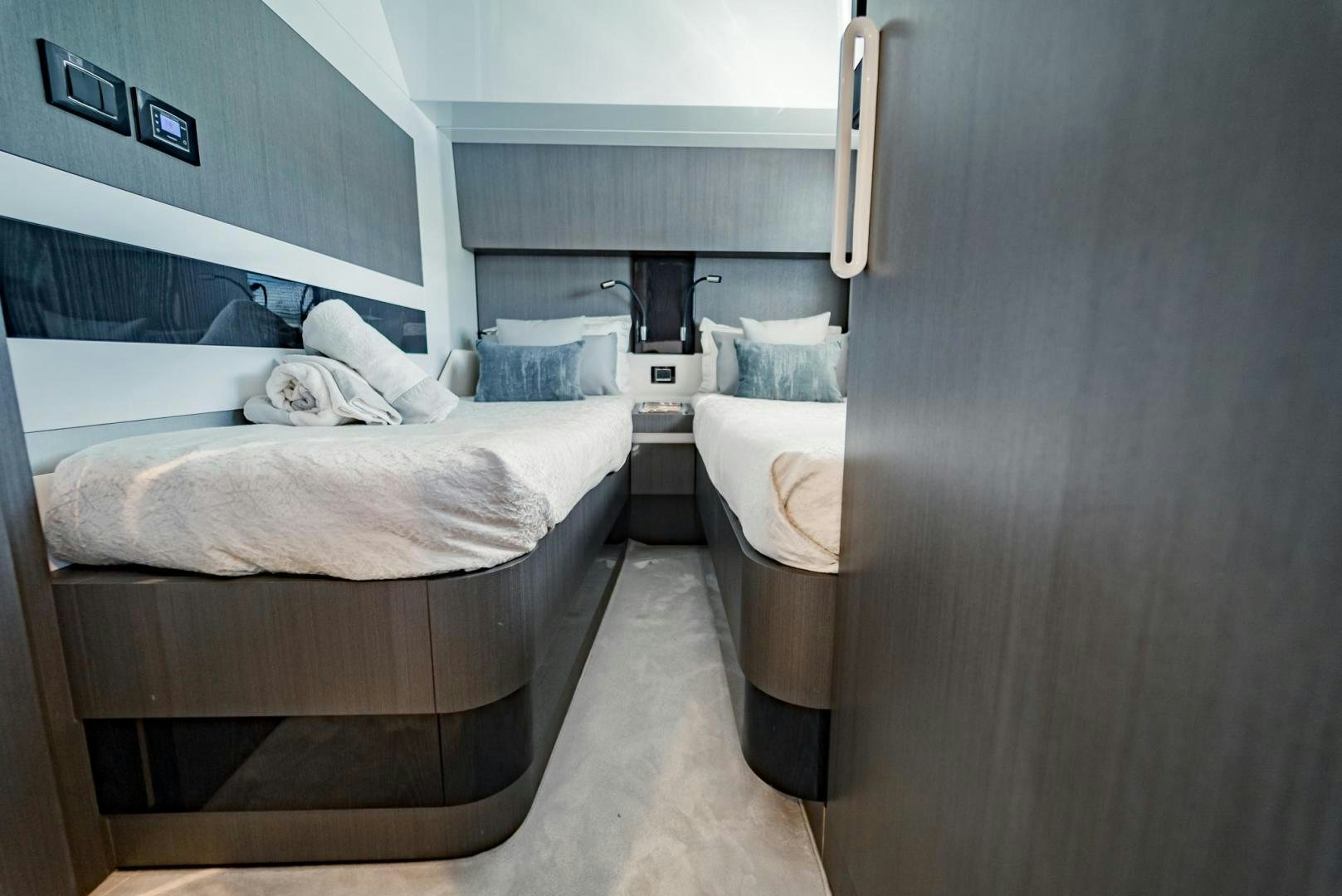 a room with a bed and a desk aboard HOME SOUTH Yacht for Sale