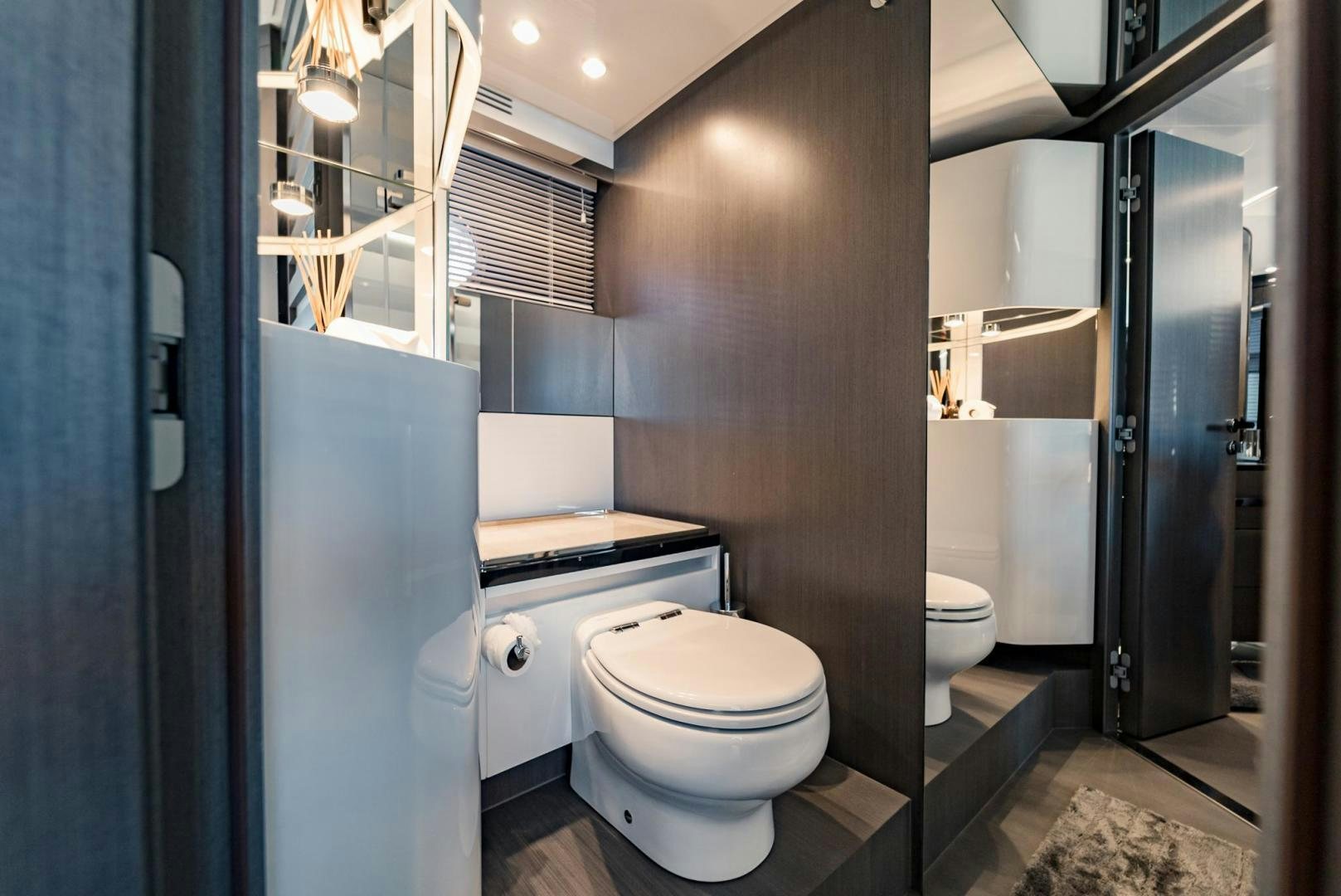 a bathroom with a toilet and a sink aboard HOME SOUTH Yacht for Sale