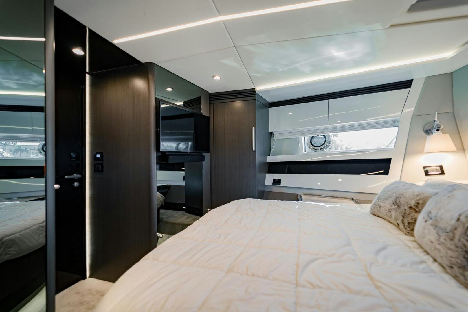 a bedroom with a bed and a desk aboard HOME SOUTH Yacht for Sale